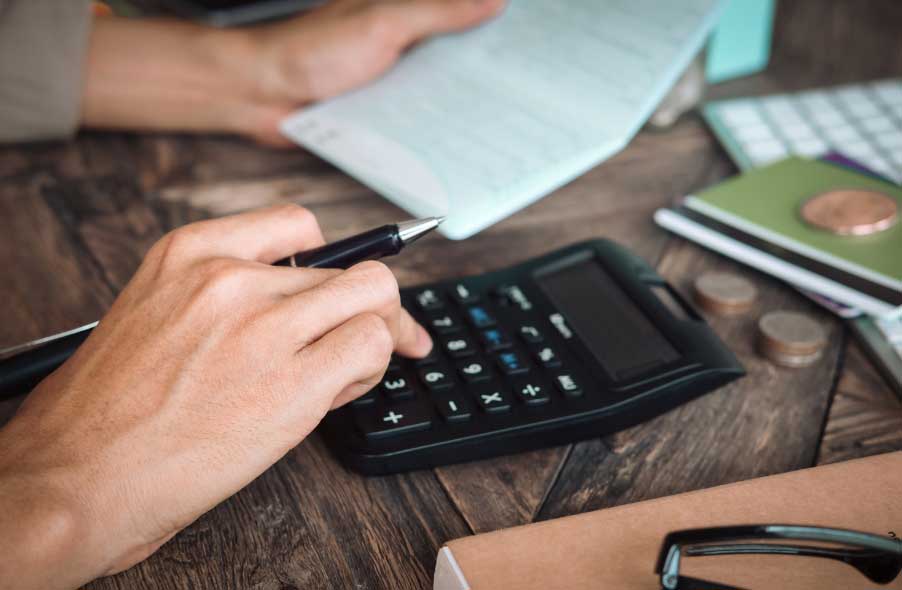 man calculating the fees in opening gold ira