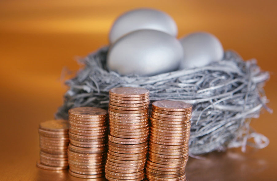 silver nest egg and stack of gold coins