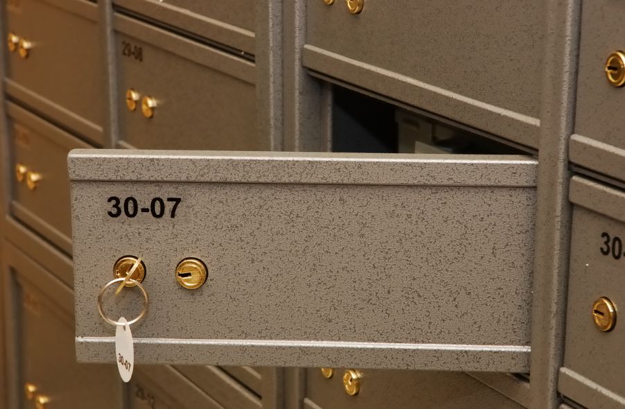 open safety deposit box inside bank vault